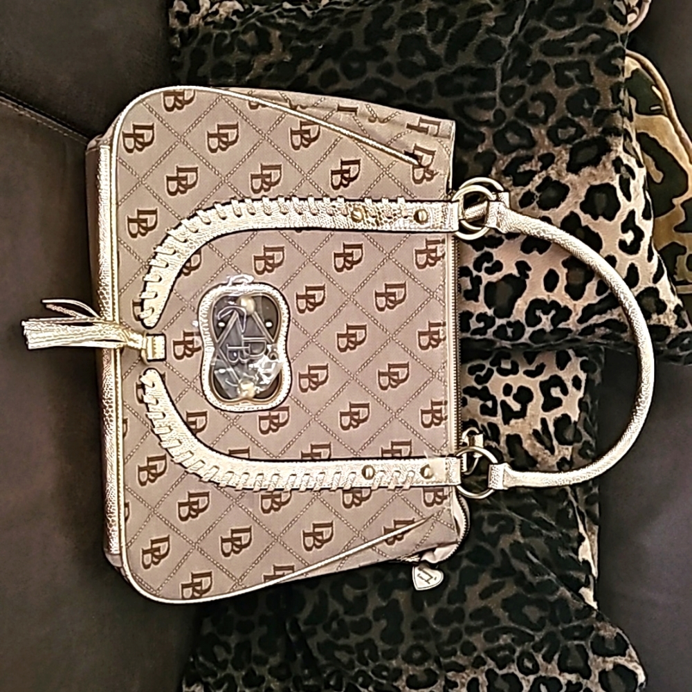 Dooney & Bourke Signature print with gold accents & Tassel